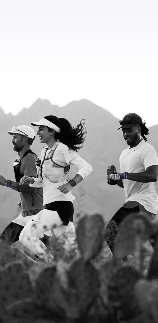Three people running on a desert trail track their workout on Apple Watch Ultra 3