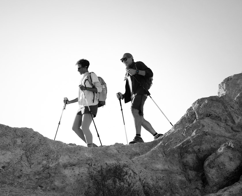 Two people wearing Apple Watch Ultra 3 hike a mountain trail