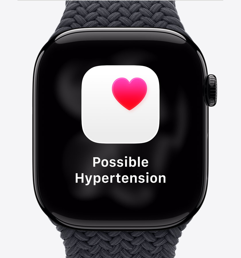 Apple Watch Series 11, aluminium case, polished Jet Black colour, possible hypertension health notification, pink heart in white box, right side exterior, Digital Crown, Braided Solo Loop, midnight colour