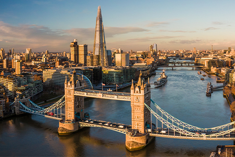 Explore Apple London Aerial view looking over London and the River Thames, with Tower Bridge in the foreground.