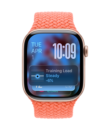 Apple Watch in Rose Gold with a braided strap in Tangerine, face shows date at top left, time with stacked numerals at top right, Training Load widget at bottom, all in translucent Liquid Glass