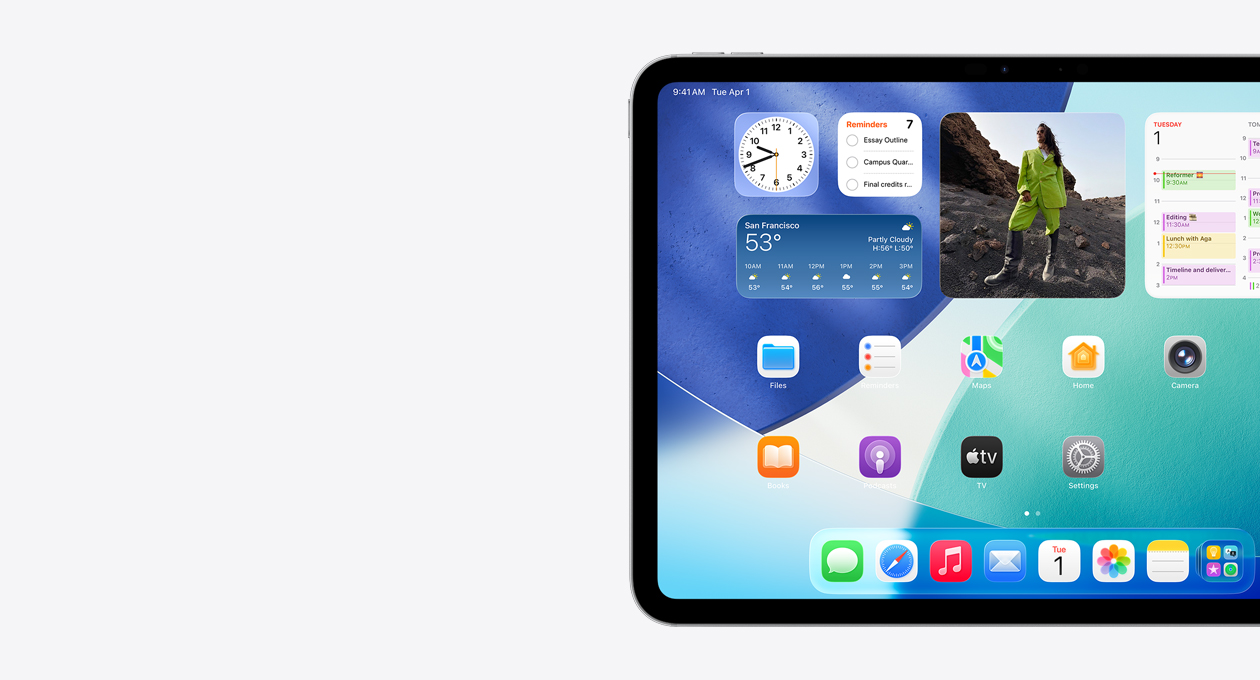 iPad, posición horizontal, sólo la parte izquierda de la pantalla, pantalla de inicio con widgets apilados, incluido el reloj translúcido que muestra el efecto Liquid Glass, la app Encontrar, el widget de Clima, dos filas de apps más pequeñas y el Dock
