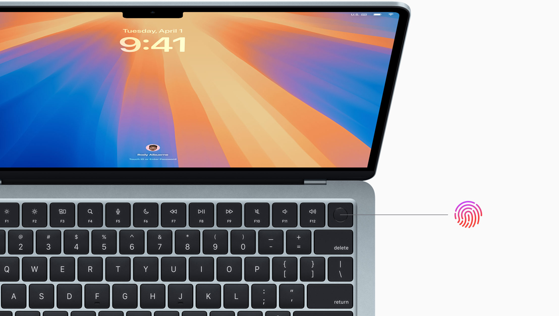 An open MacBook Pro in Space Black, demonstrating the location of the Touch ID button.