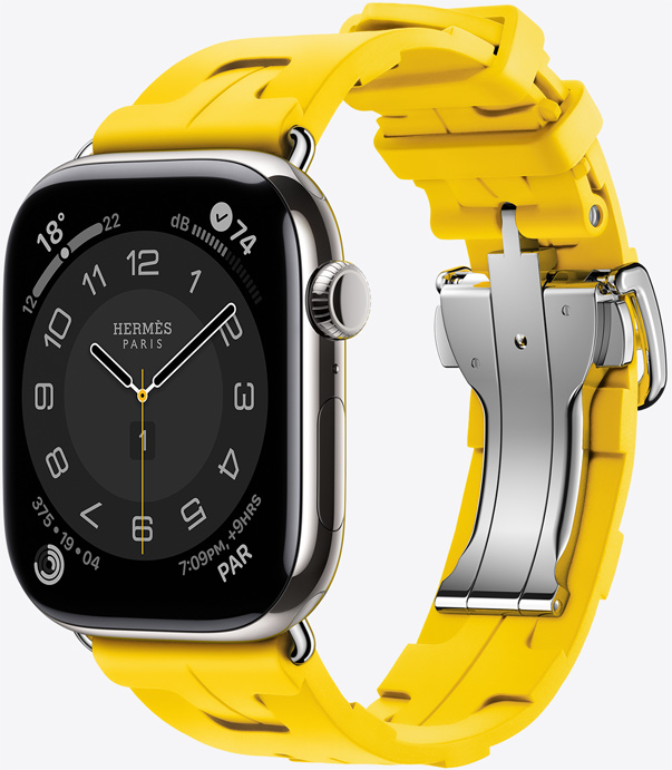 Angled view of the rubber Kilim band in Sun (yellow) showing the quick-release metal buckle and the Hermès Circulaire watch face.