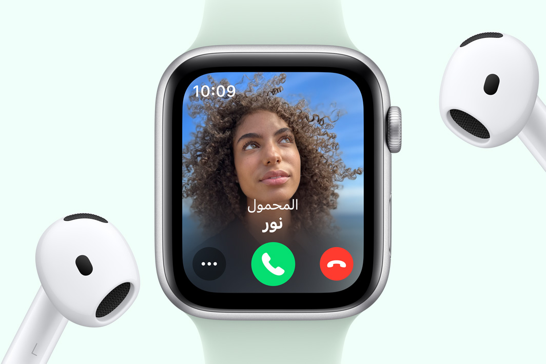Apple Watch SE showing an incoming call, next to a pair of AirPods