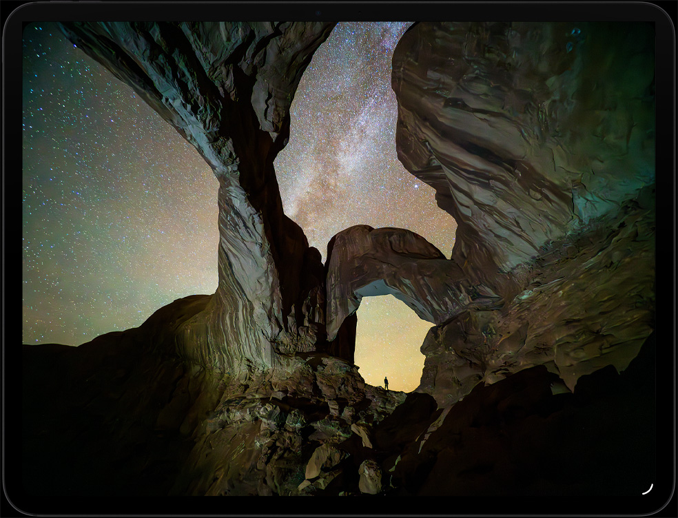 iPad Pro, display with image of 2 people entering a futuristic interior in the Apple TV+ series Silo.