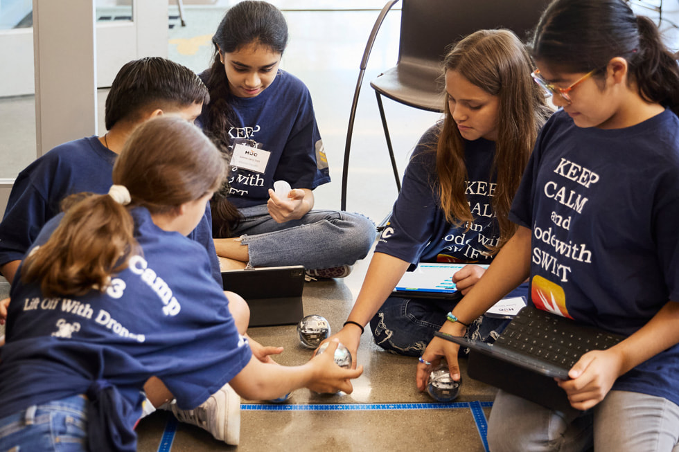 Sisters Soleil (far left) and Lluvia San Miguel (second from right) work with their fellow campers to guide Sphero robots through an obstacle course at Houston Community College’s technology summer camp.