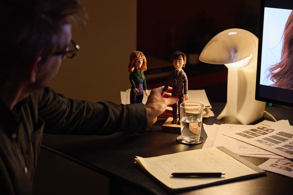 Ben Stiller touches figurines of two main characters from “Severance”.