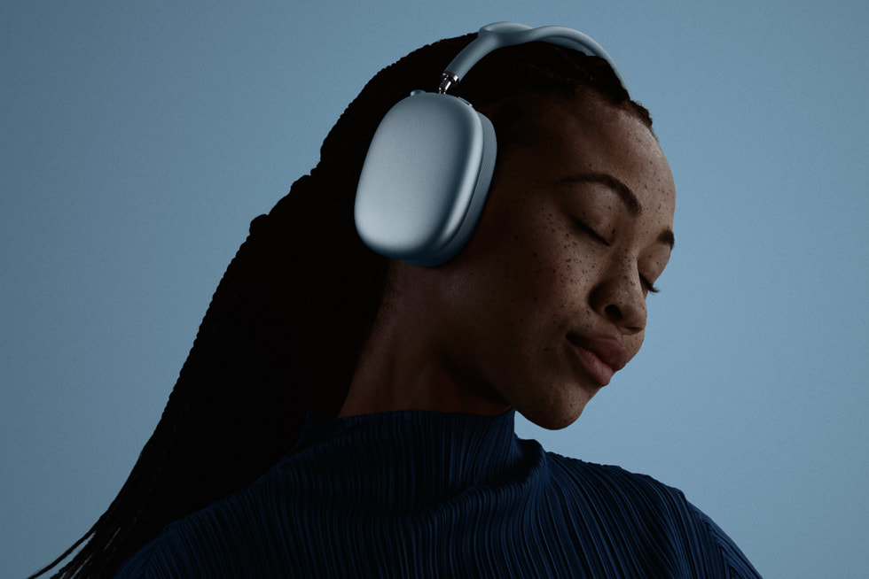 Una persona con los ojos cerrados tiene puestos unos AirPods Max 2 azules.