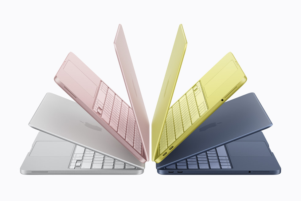 Différents modèles de MacBook Neo sont disposés en éventail pour montrer les quatre coloris : argent, rose poudré, jaune agrume et indigo. 