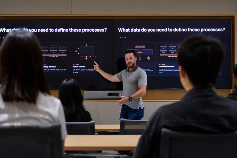 A presenter stands in front of a screen that reads “What data do you need to define these processes?” at Apple’s Advanced Manufacturing Center in Houston.