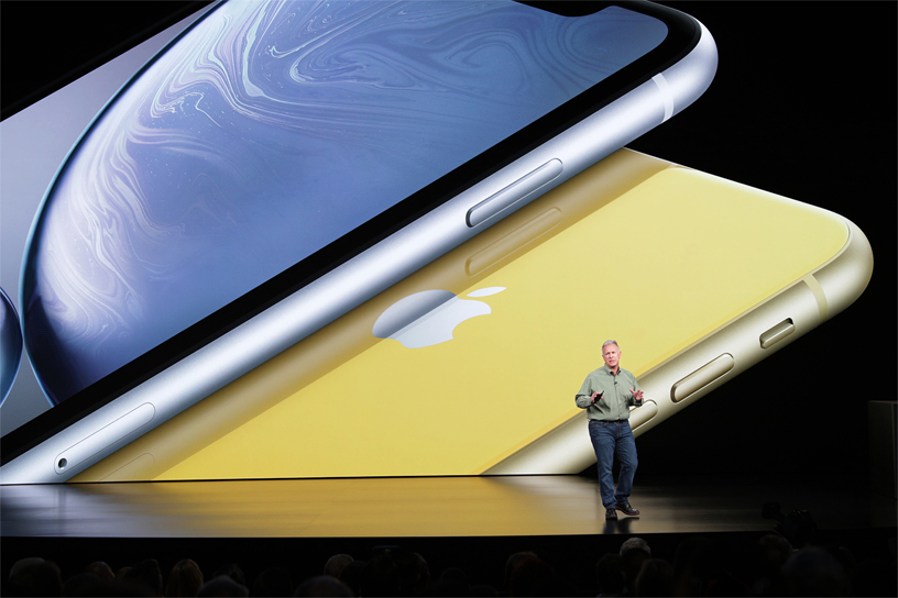 Sahnede iPhone XR görüntüsünün önünde duran Phil Schiller.
