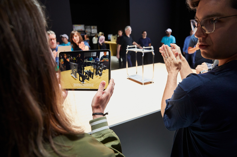 iPad의 AR 화면을 보고 있는 WWDC 참가자.