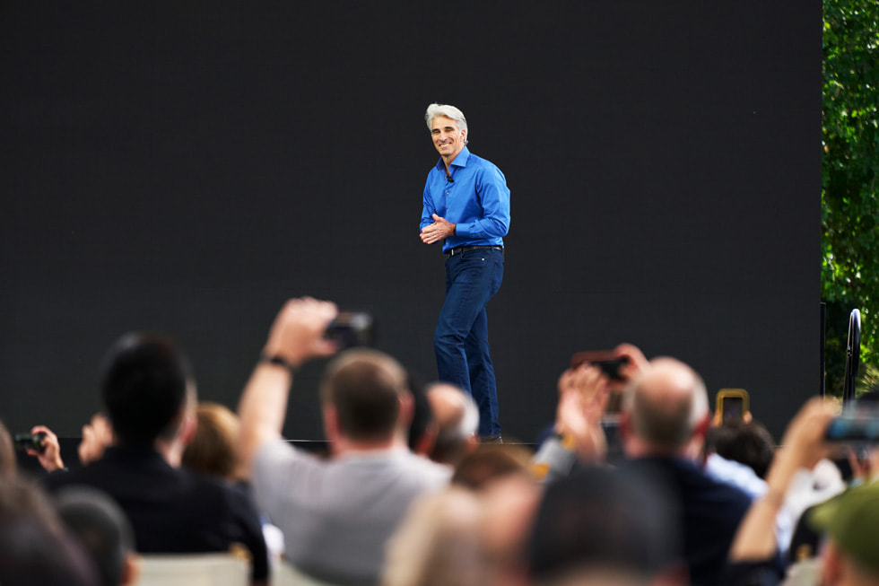 Craig Federighi na pódiu konference WWDC23 promlouvá k vývojářům.