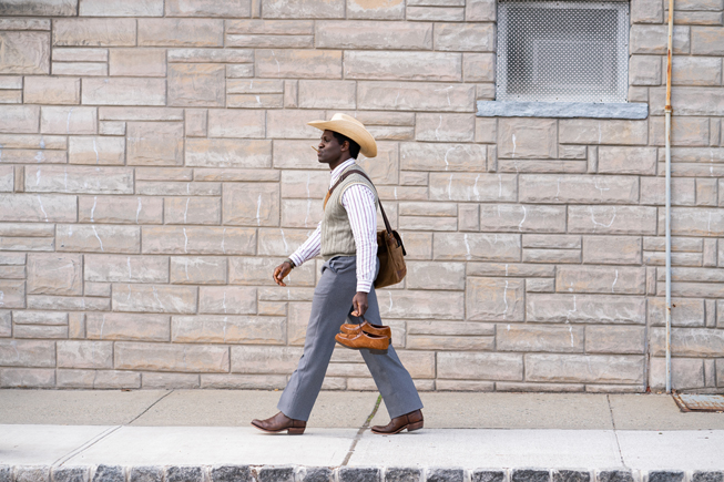 Conphidance marchant dans la rue dans « Little America ».