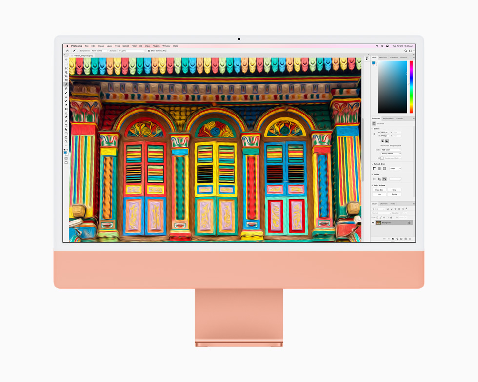 Photoshop에서 편집한 이미지를 보여주는 오렌지 색상의 iMac.