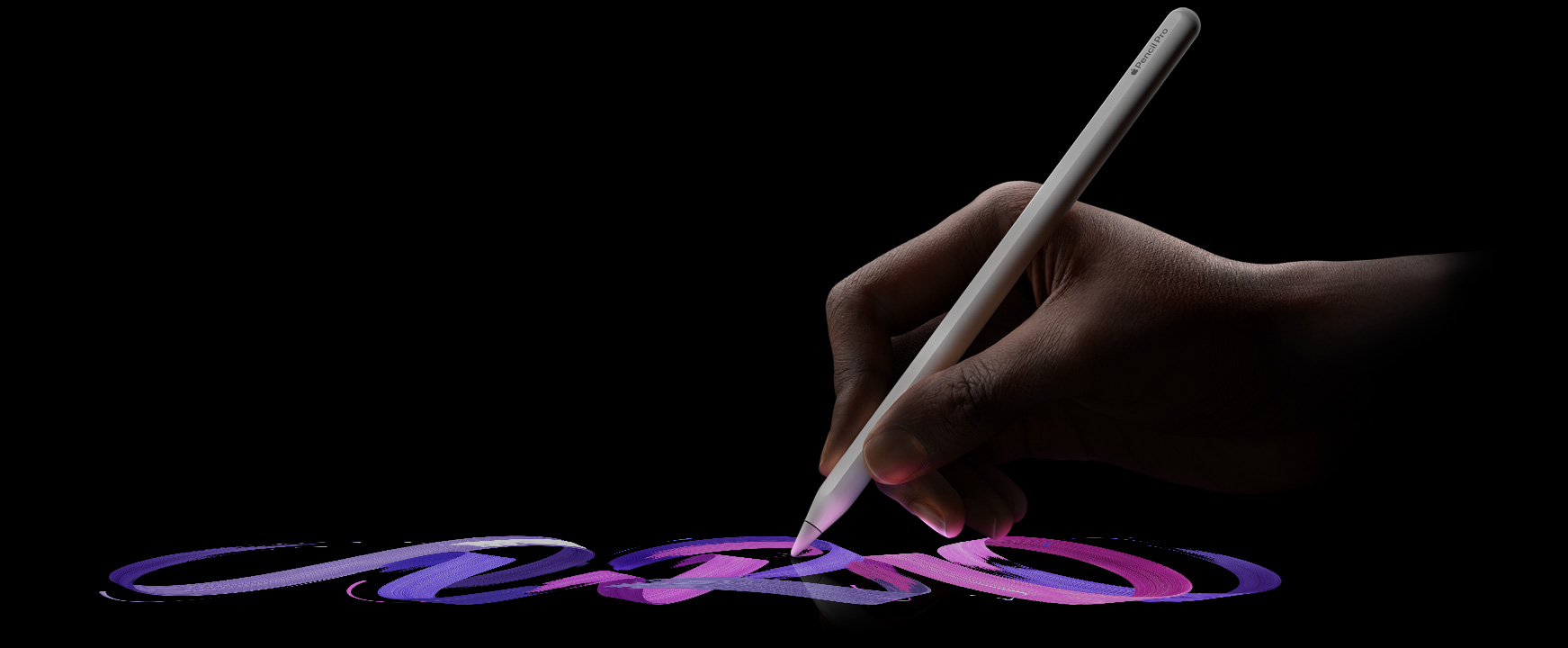 ユーザーがApple Pencil Proを持ち、色あざやかなブラシの線を描いている