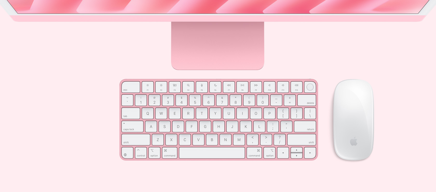 俯視圖展示粉紅色 iMac 配上襯色的滑鼠和鍵盤