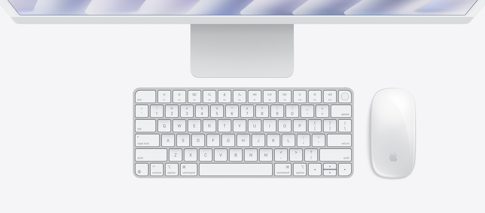 俯視圖展示銀色 iMac 配上襯色的滑鼠和鍵盤