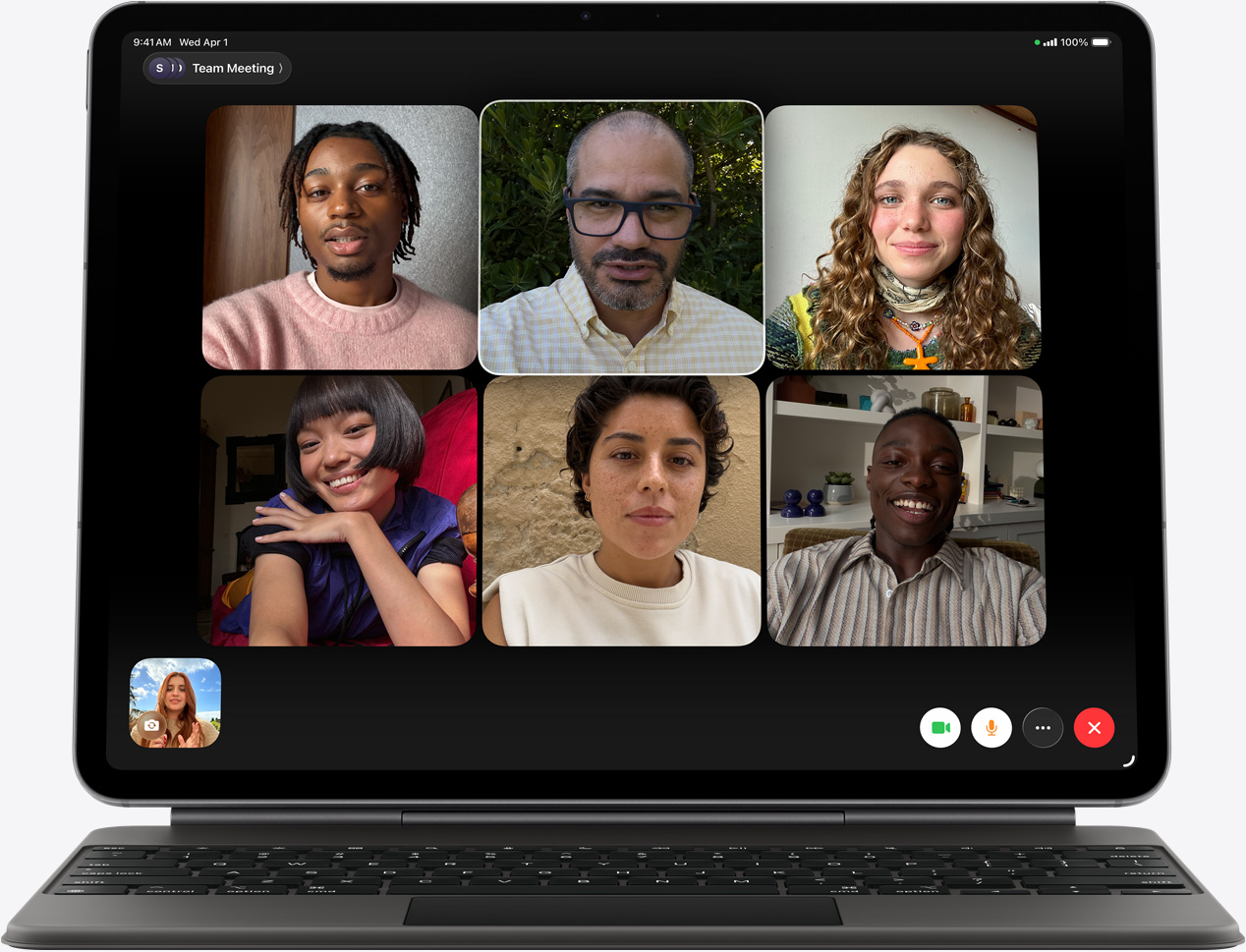 iPad Air 的機身正面、黑色精妙鍵盤，螢幕顯示 FaceTime 通話中，可以看到有幾位參與者。	