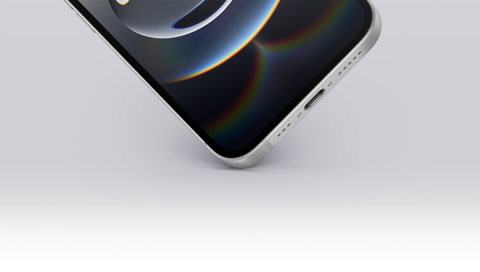 iPhone 16eの下部の隅が地面に接触する様子。USB-Cポートが見えている