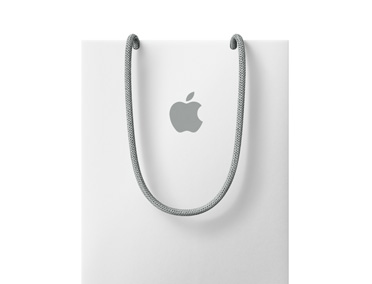 Bílá nákupní taška s logem Apple v horní části