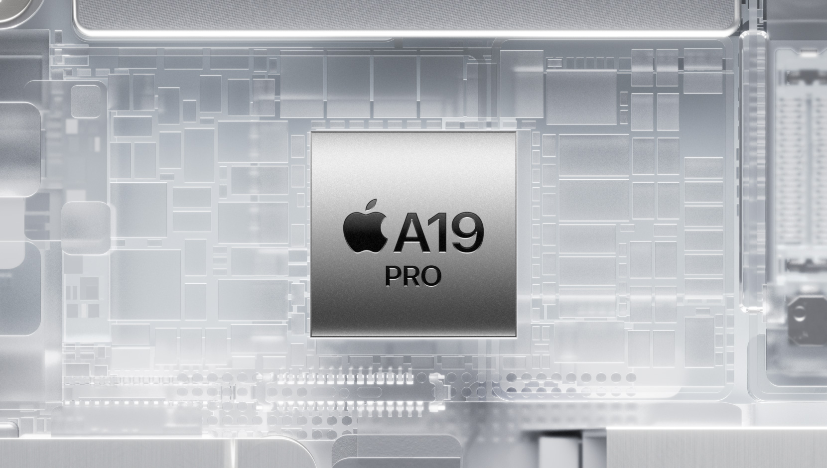 Chip A19 Pro dikelilingi oleh komponen interior iPhone yang bercahaya