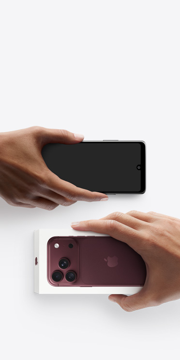 Hands exchanging phones, Android on the left without a box, on the right is a new iPhone Air in box