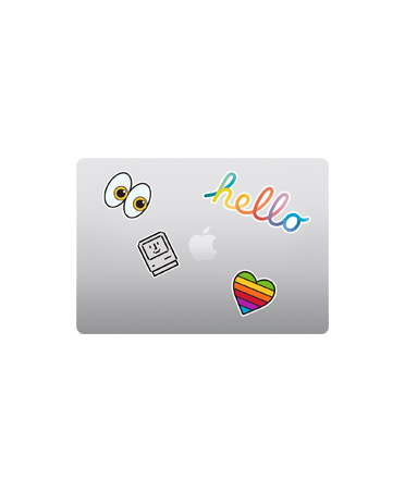 MacBook Air, top exterior, closed, silver colour, multi-coloured stickers surrounding Apple logo
