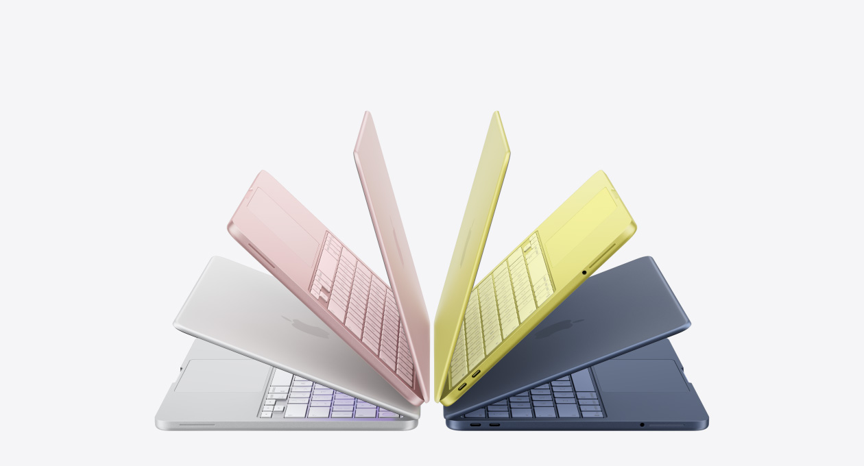 Laptops MacBook Neo en los colores plata, rosa rubor, amarillo cítrico e índigo, levemente abiertas y acomodadas en forma de arco