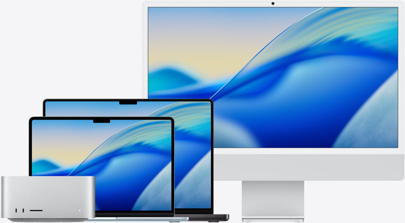 The macOS Tahoe wallpaper across family of Mac models from left to right: Mac Studio, 13-in MacBook Air in Sky Blue, 14-in MacBook Bro in Space Black, and 24-in iMac in Silver