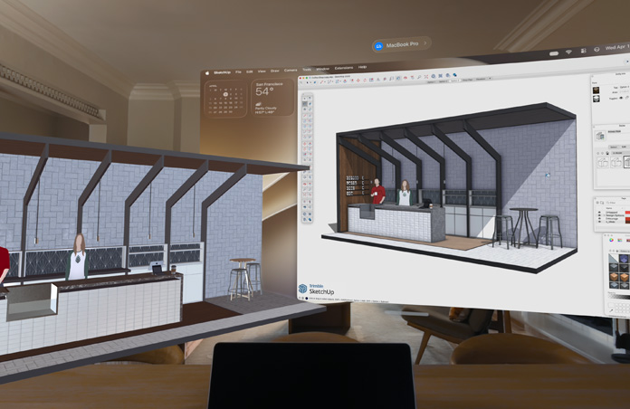 Apple Vision Pro view, MacBook Pro sits on a surface with 3D models projected behind it, models show a cafe service counter with two people standing behind it