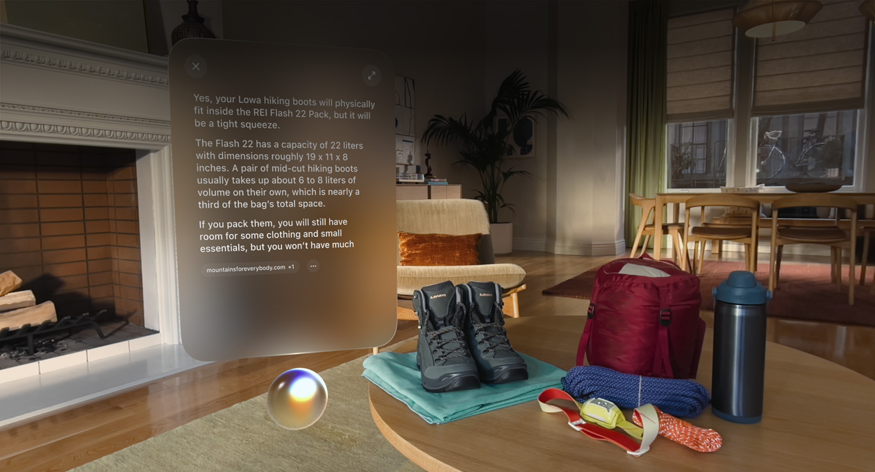 Apple Vision Pro view, a conversation with Siri about hiking boots fitting in a backpack hovers above Siri and to the left of a pair of hiking boots and other outdoor gear